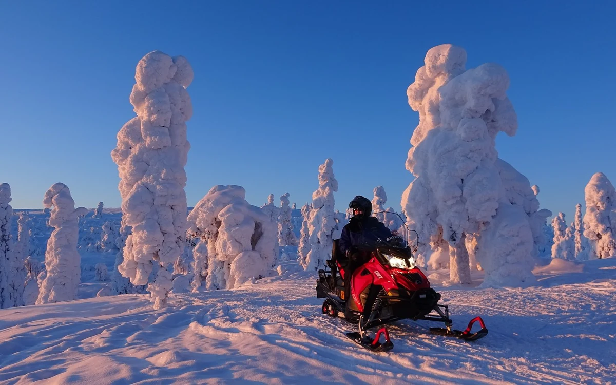 Warm winter clothing and boots in the snow on a dark evening in Lapland